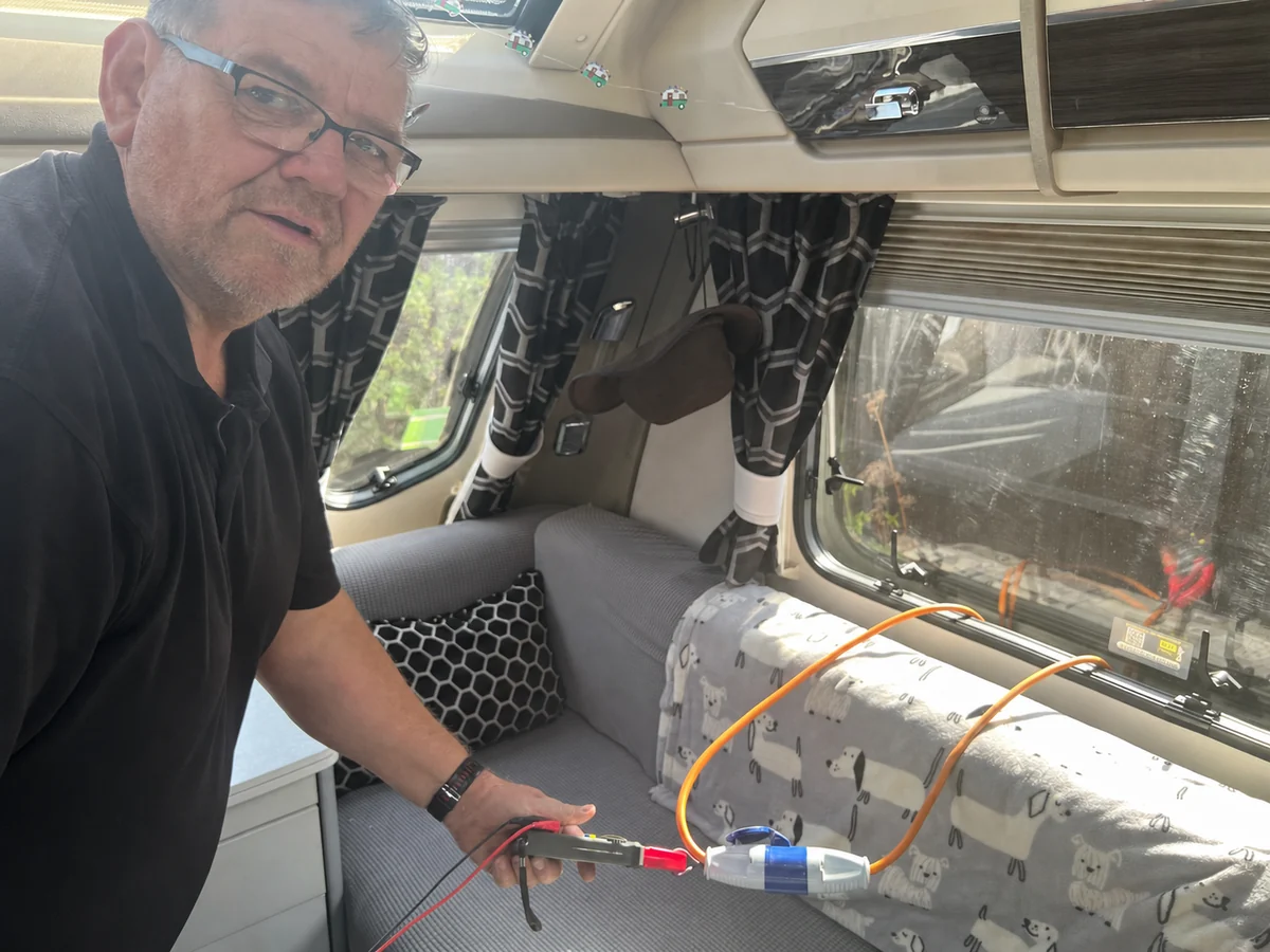 Peter carrying out an appliance check inside a caravan